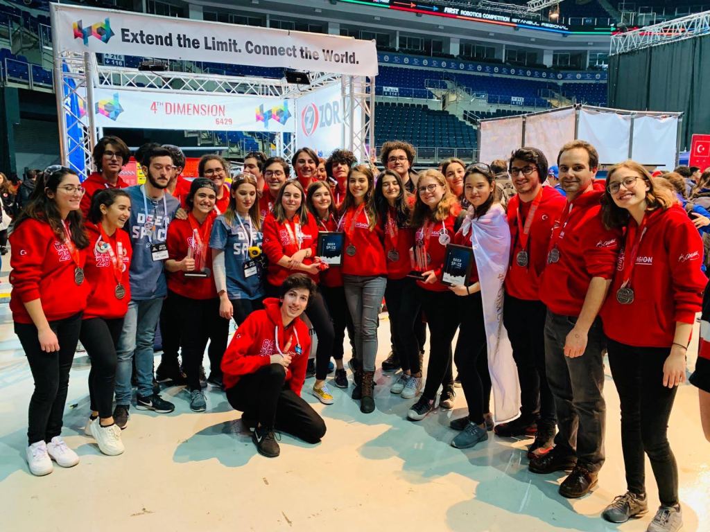 Team 6429 members in red jackets at a FIRST Robotics Competition.